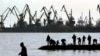 Ukraine -- People fish on a pier at the port of Mariupol, located on the north of the Sea of Azov in eastern Ukraine, March 26, 2014